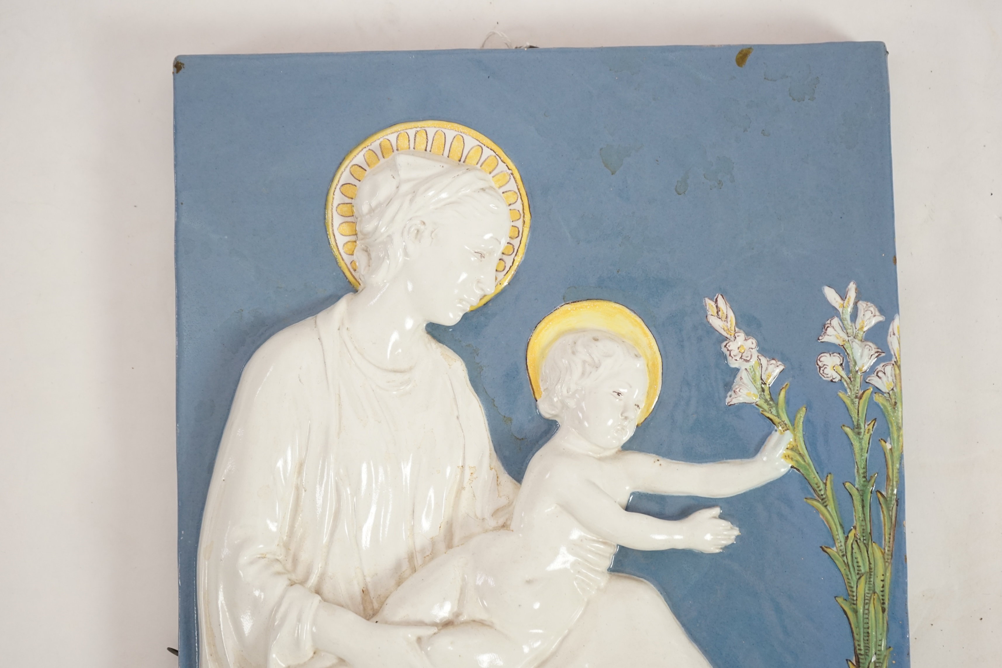 A Cantagalli maiolica wall plaque depicting the Virgin and child, 19th century, after Della Robbia